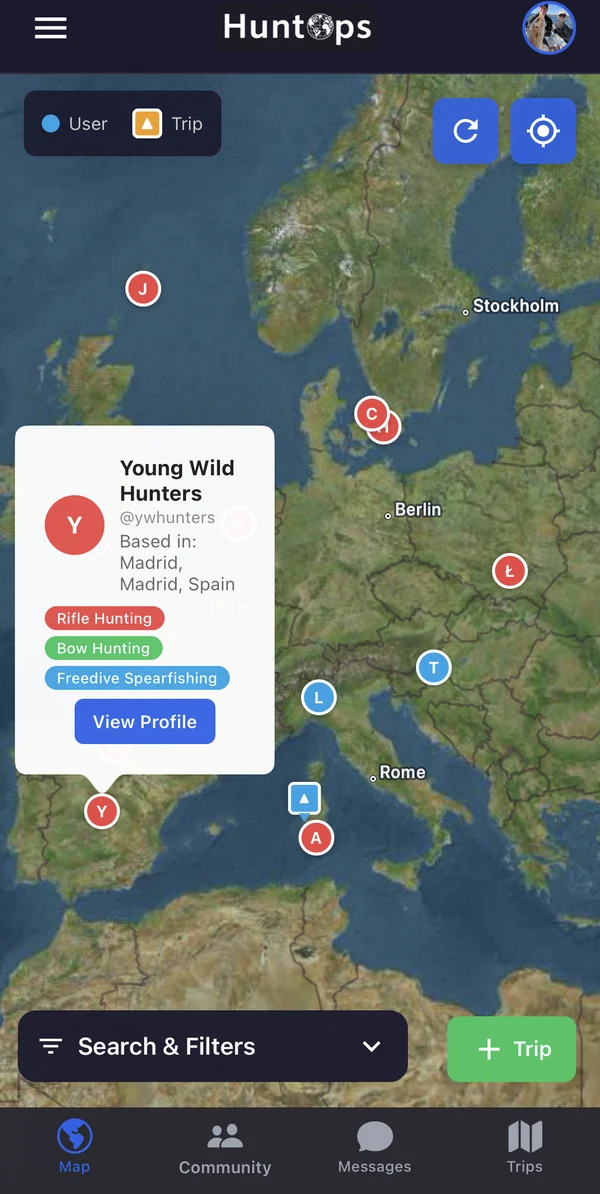 HuntOps mobile map of Europe with an open user card showing a location, hunting and spearfishing interests, and a View Profile button.