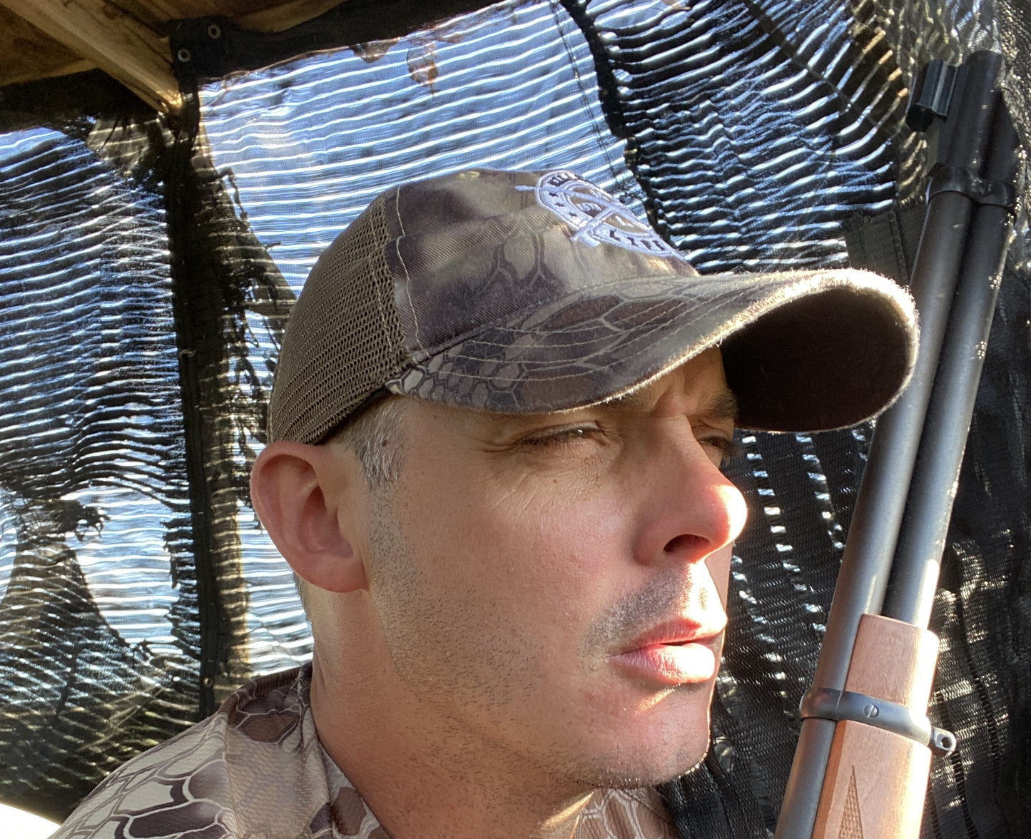 In the deerstand looking for an axis buck with the killshot life kryptek brown camo trucker hat