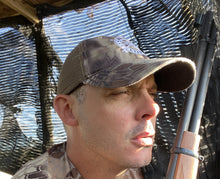 Load image into Gallery viewer, In the deerstand looking for an axis buck with the killshot life kryptek brown camo trucker hat
